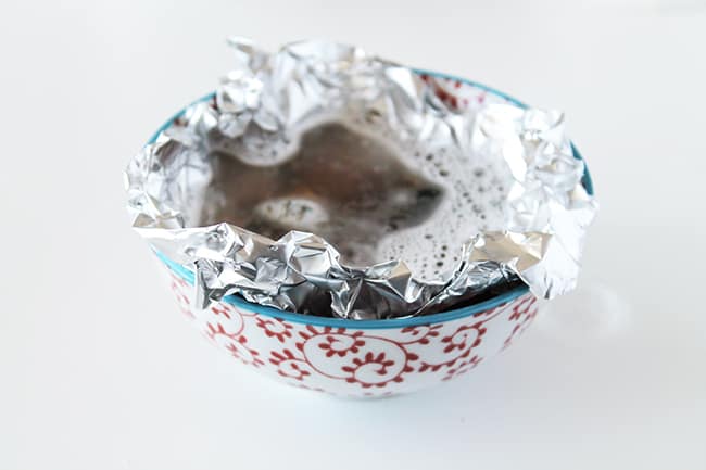 Add jewelry to bowl lined with aluminum foil