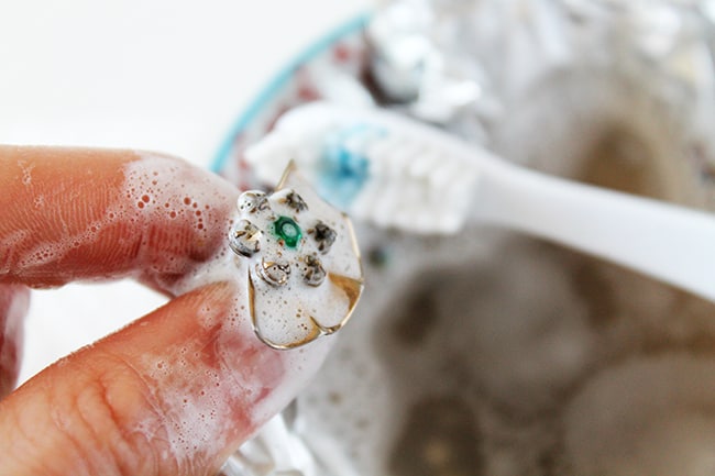 Use soft toothbrush to clean jewelry