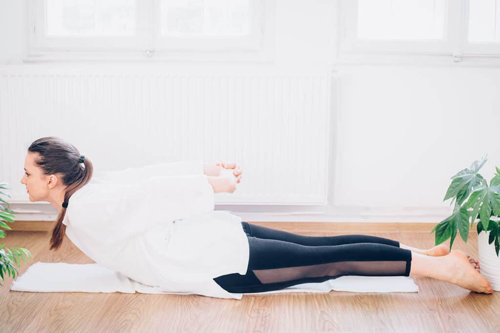 Locust pose for hunched shoulders