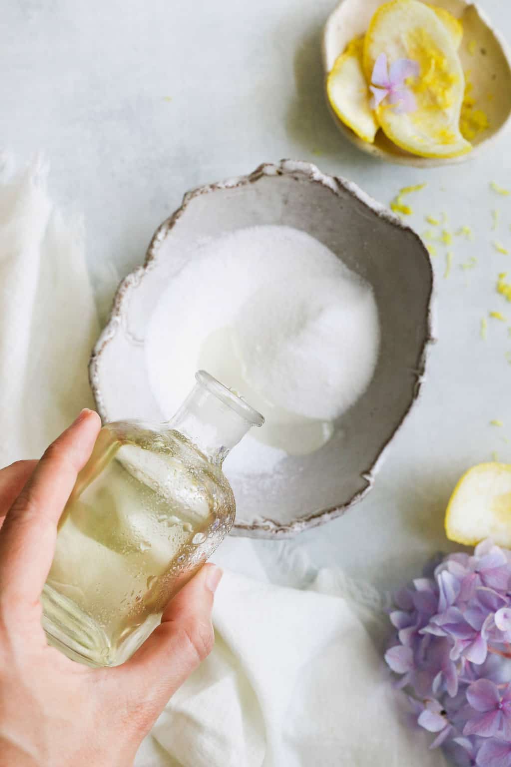 Mixing sugar and oil for a lemon vanilla sugar scrub