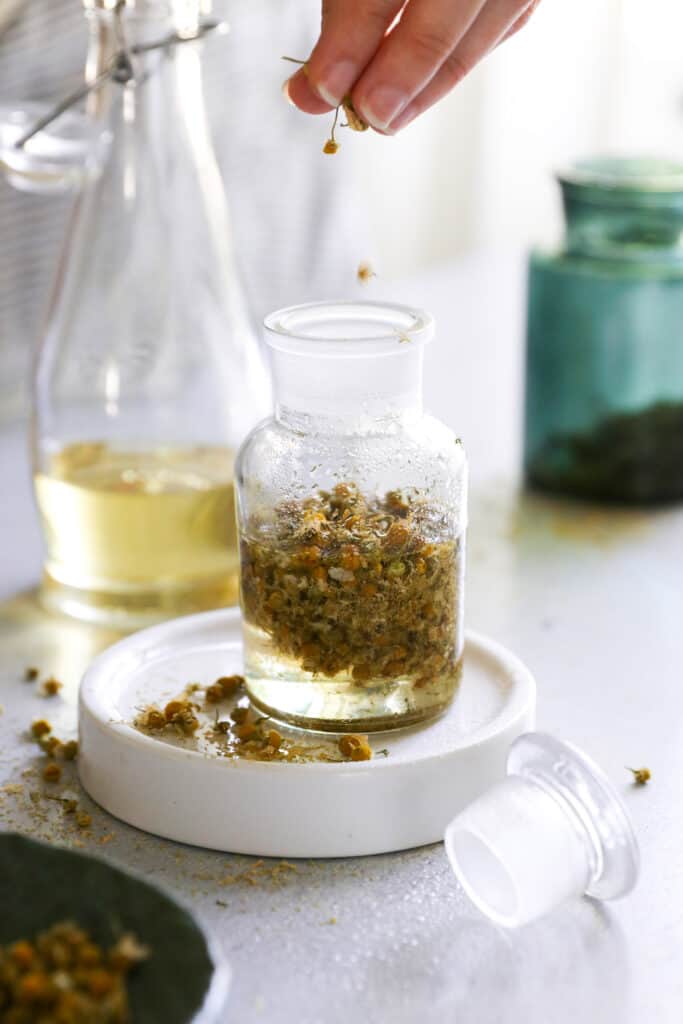 This DIY chamomile bath oil soothes dry winter skin and eases tension and stress with the power of infused chamomile flowers.