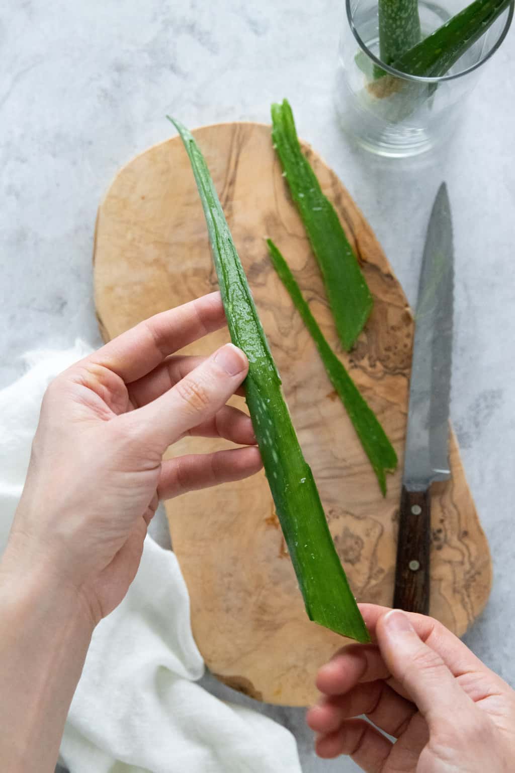 Cut aloe leaf in half to harvest fresh aloe gel