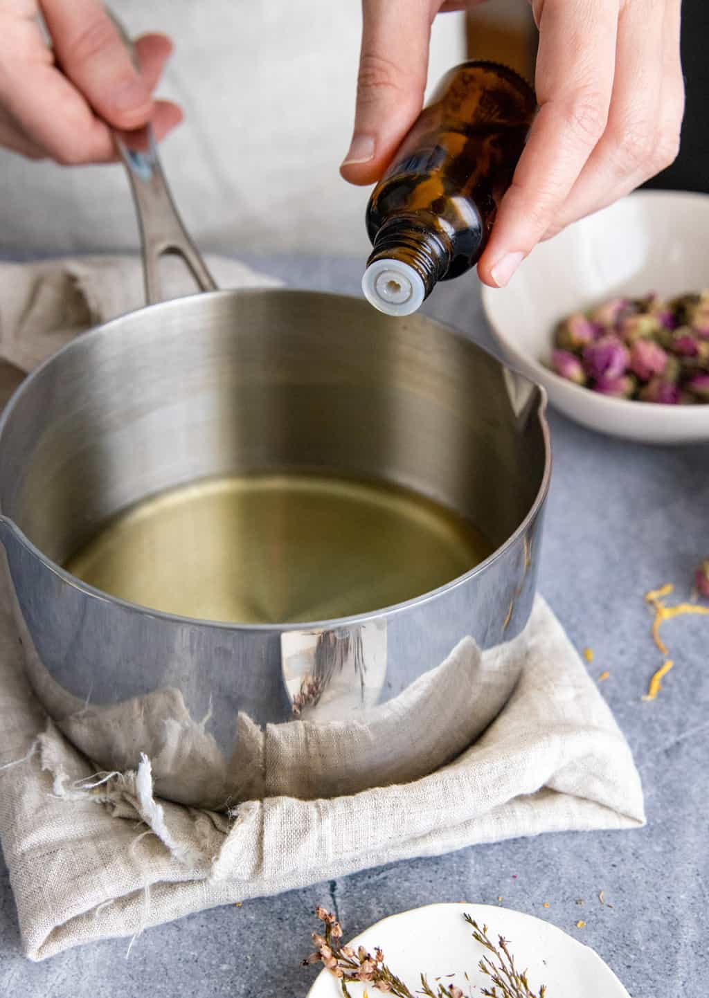 Add essential oil to melted wax and oil in herbal salve recipes