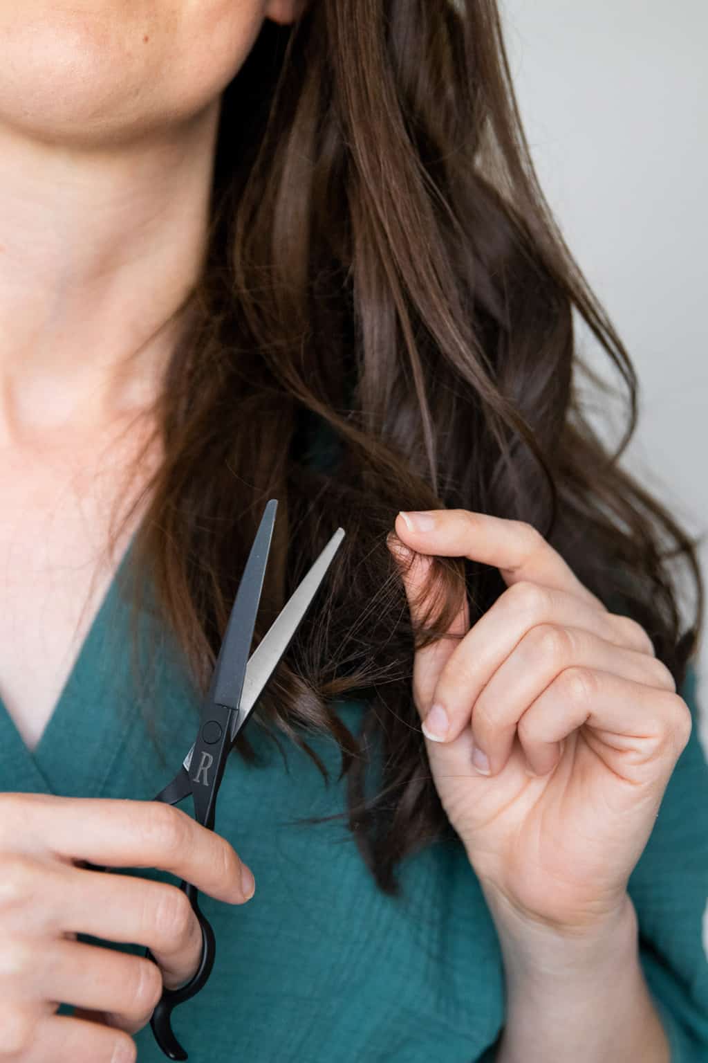 Grab a pair of hair cutting shears and a couple hair ties - we'll show you how to cut your hair at home with the ponytail method