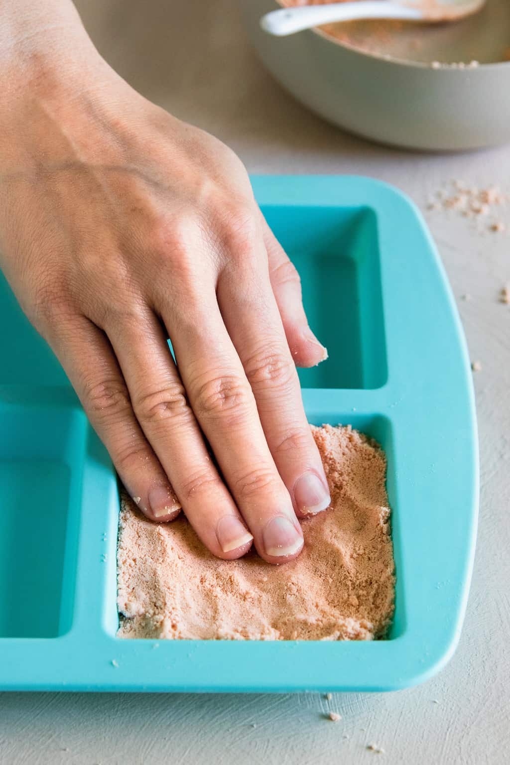 Press shower steamers into mold to dry