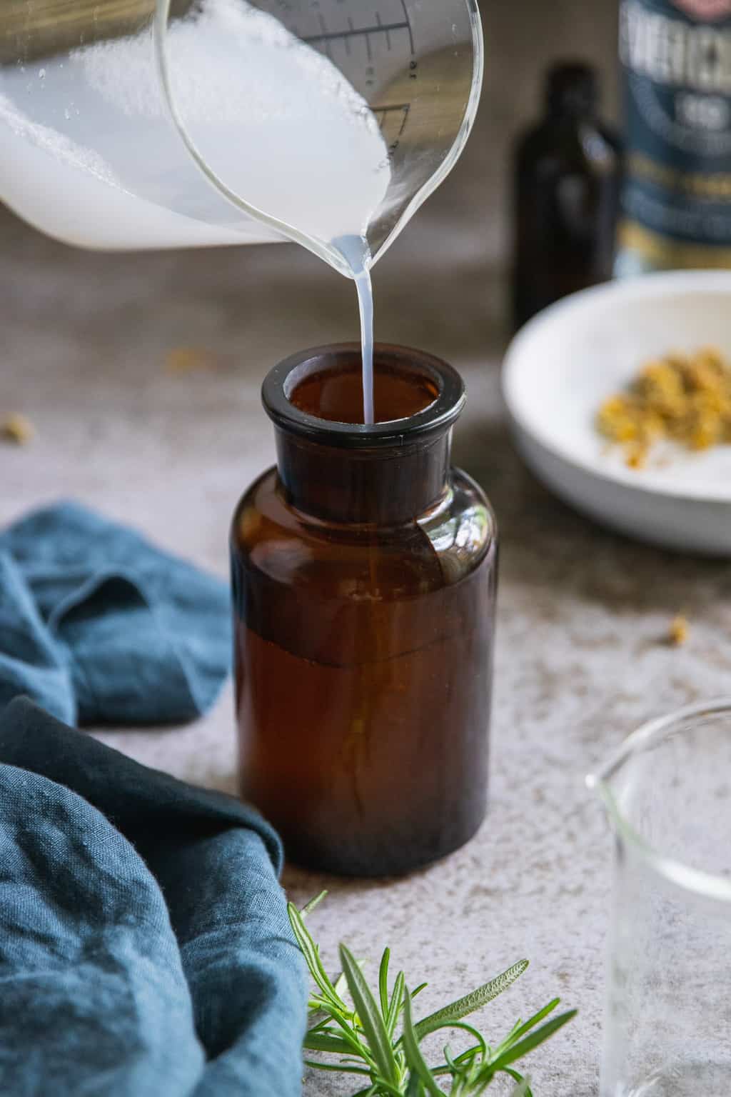 Store homemade aftershave in an amber glass bottle with a lid.