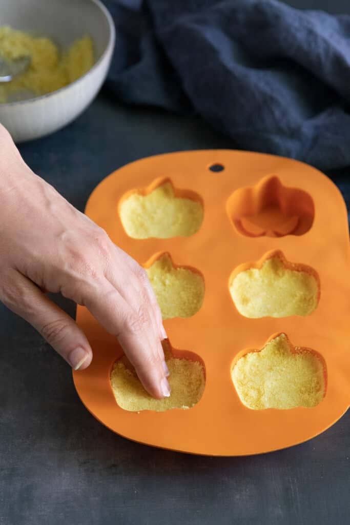 Press bath bombs into Halloween molds