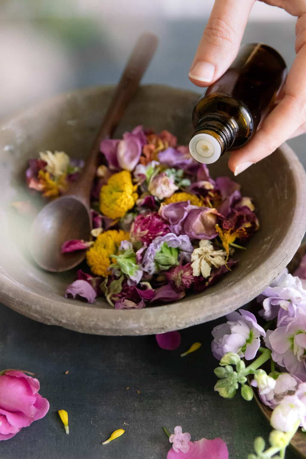 Adding essential oils to homemade potpourri for a natural scent