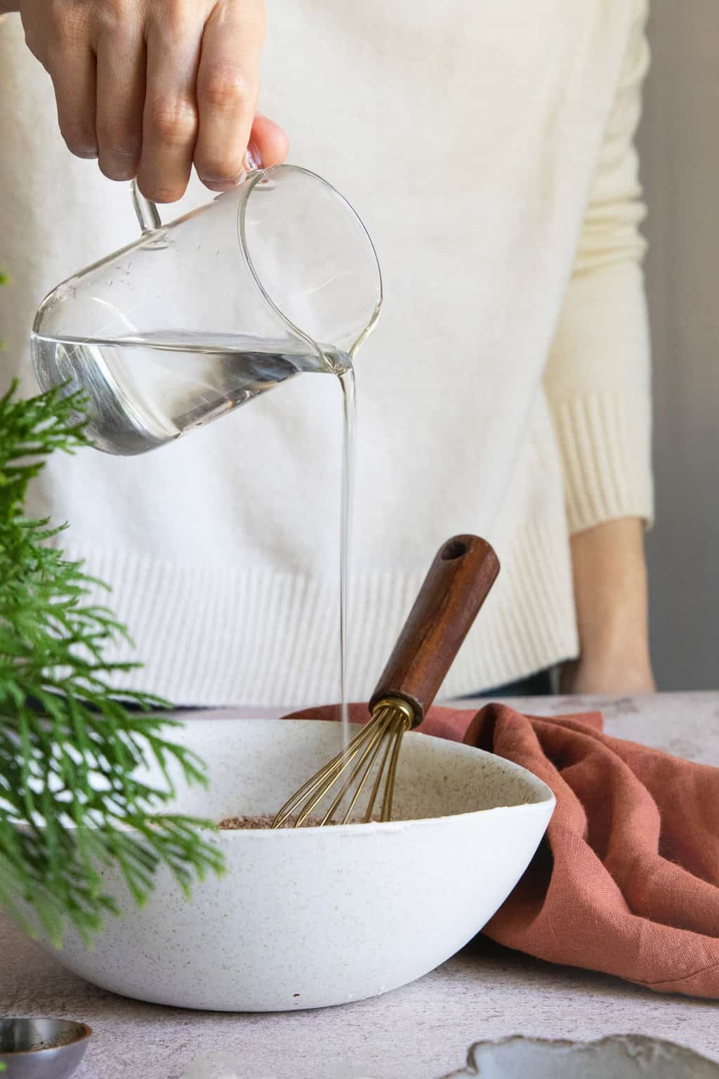 Adding water to make cinnamon dough for ornaments