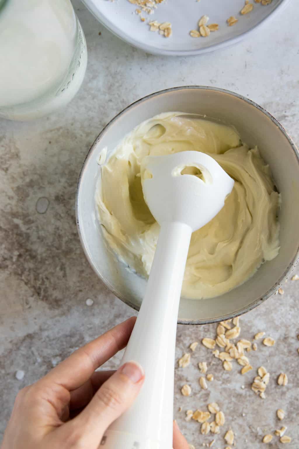 Combine oil and water phases with an immersion blender for homemade lotion