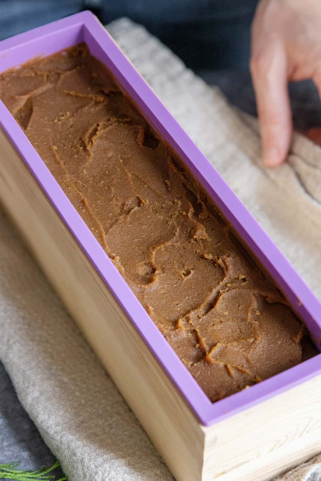 pouring pine tar soap into soap molds