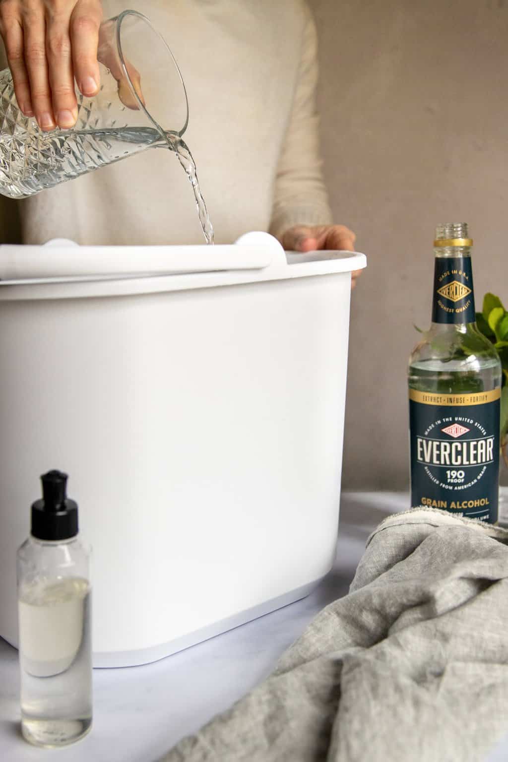 Mixing homemade floor cleaner ingredients in a bucket