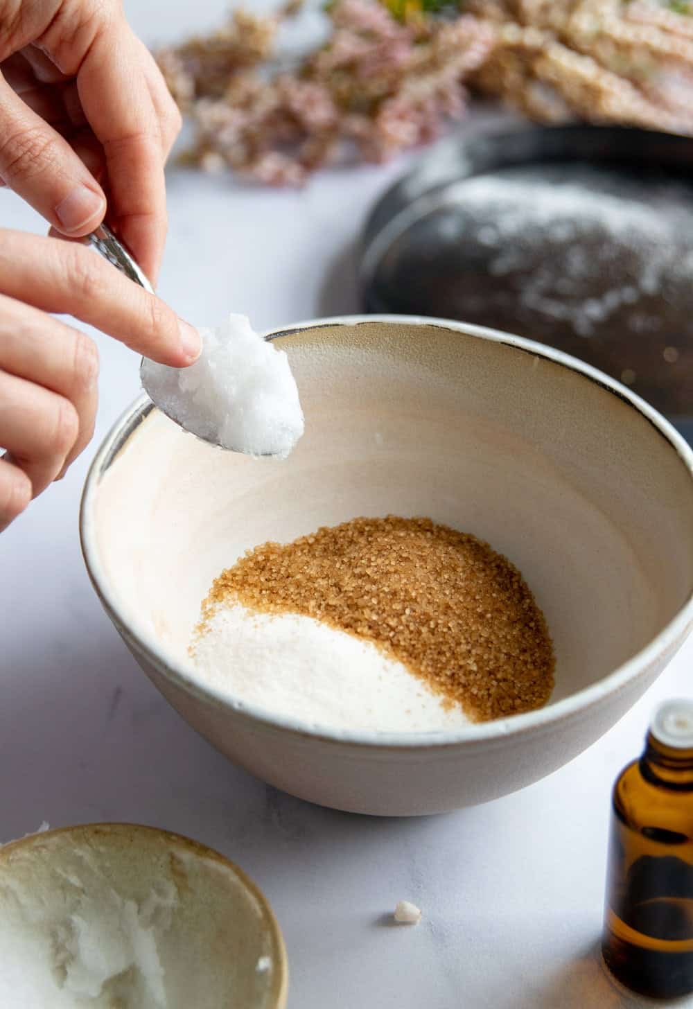 Combine the sugar and oils in a bowl for a whipped sugar scrub