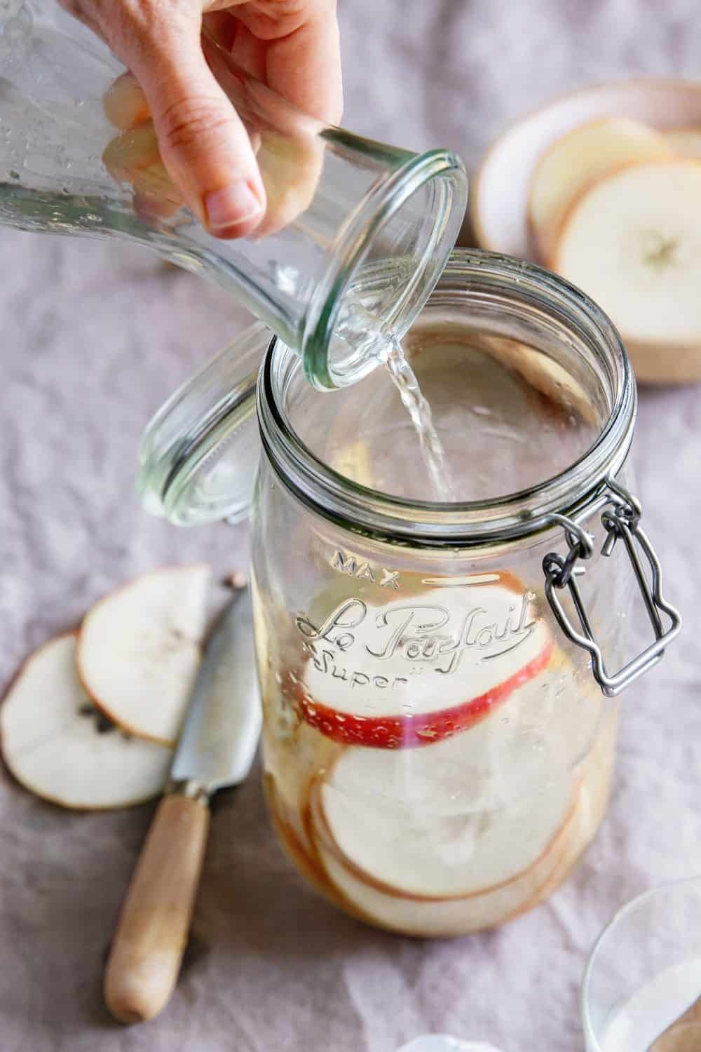 Combine apples and sugar water to make homemade apple cider vinegar