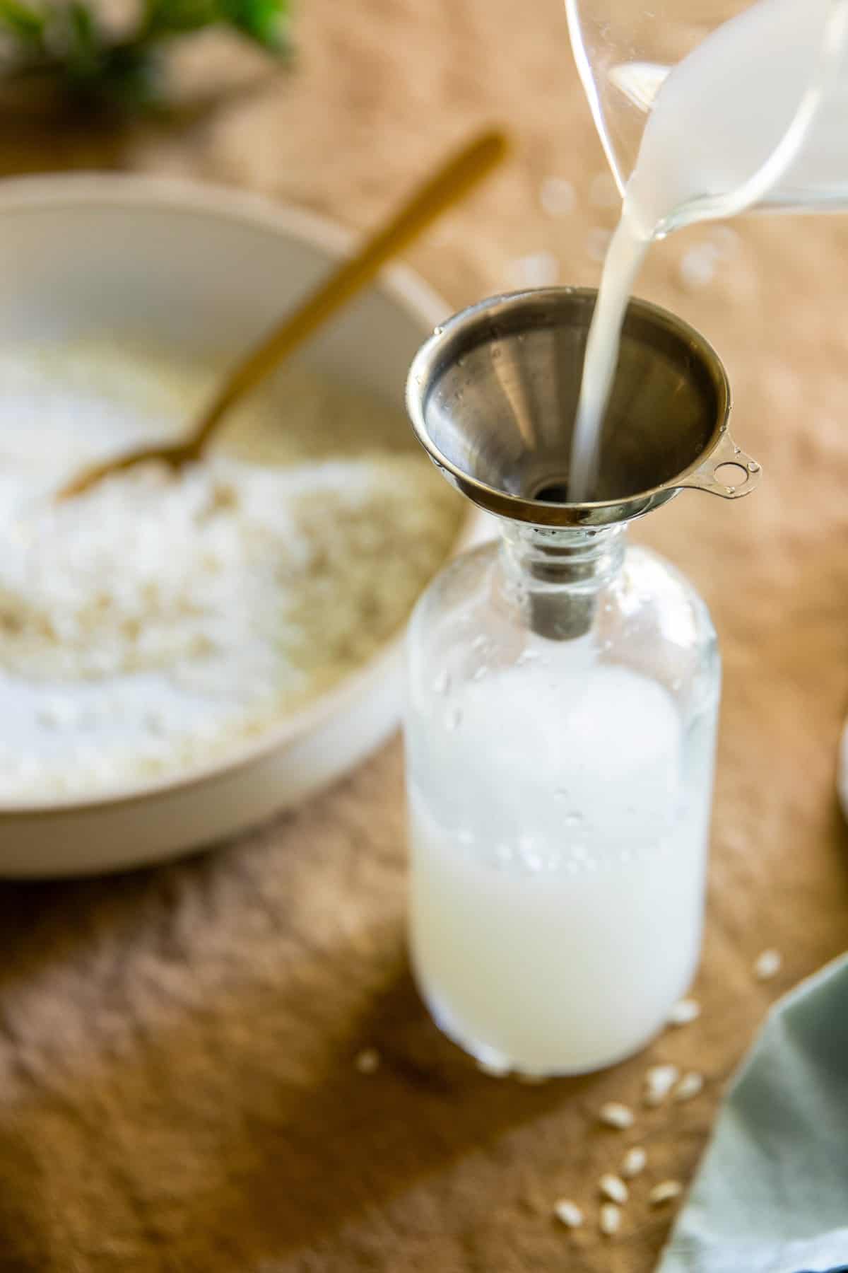 Pouring rice water toner into glass container