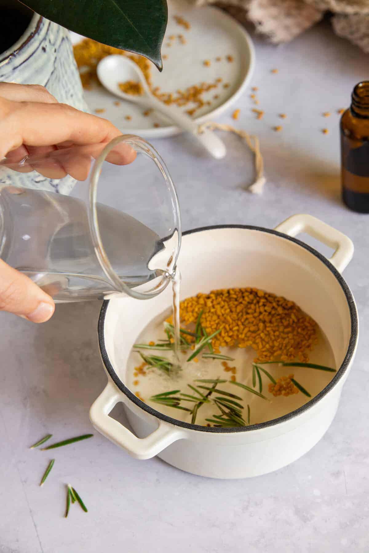 Combine fenugreek and rosemary with water to make scalp serum infusion