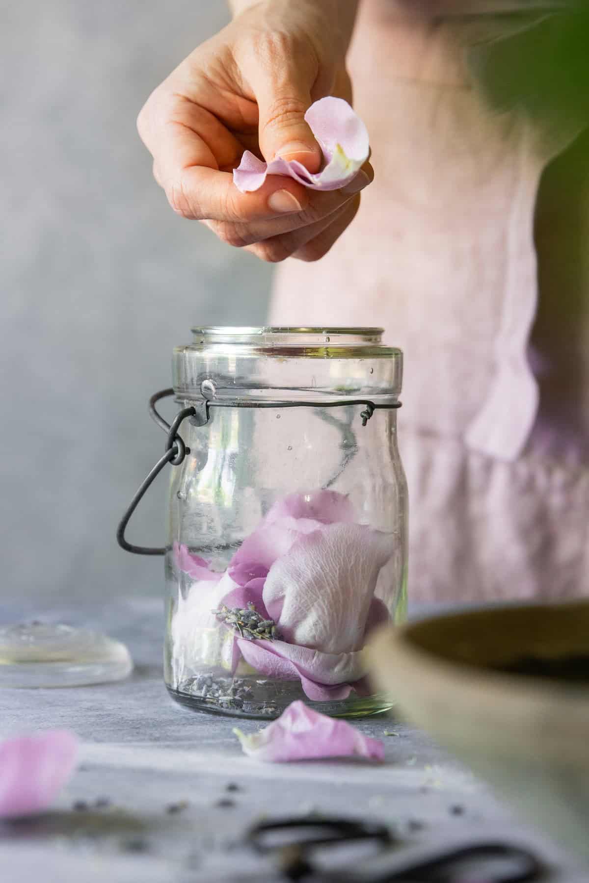 Add rose petals to jar for making perfume oil